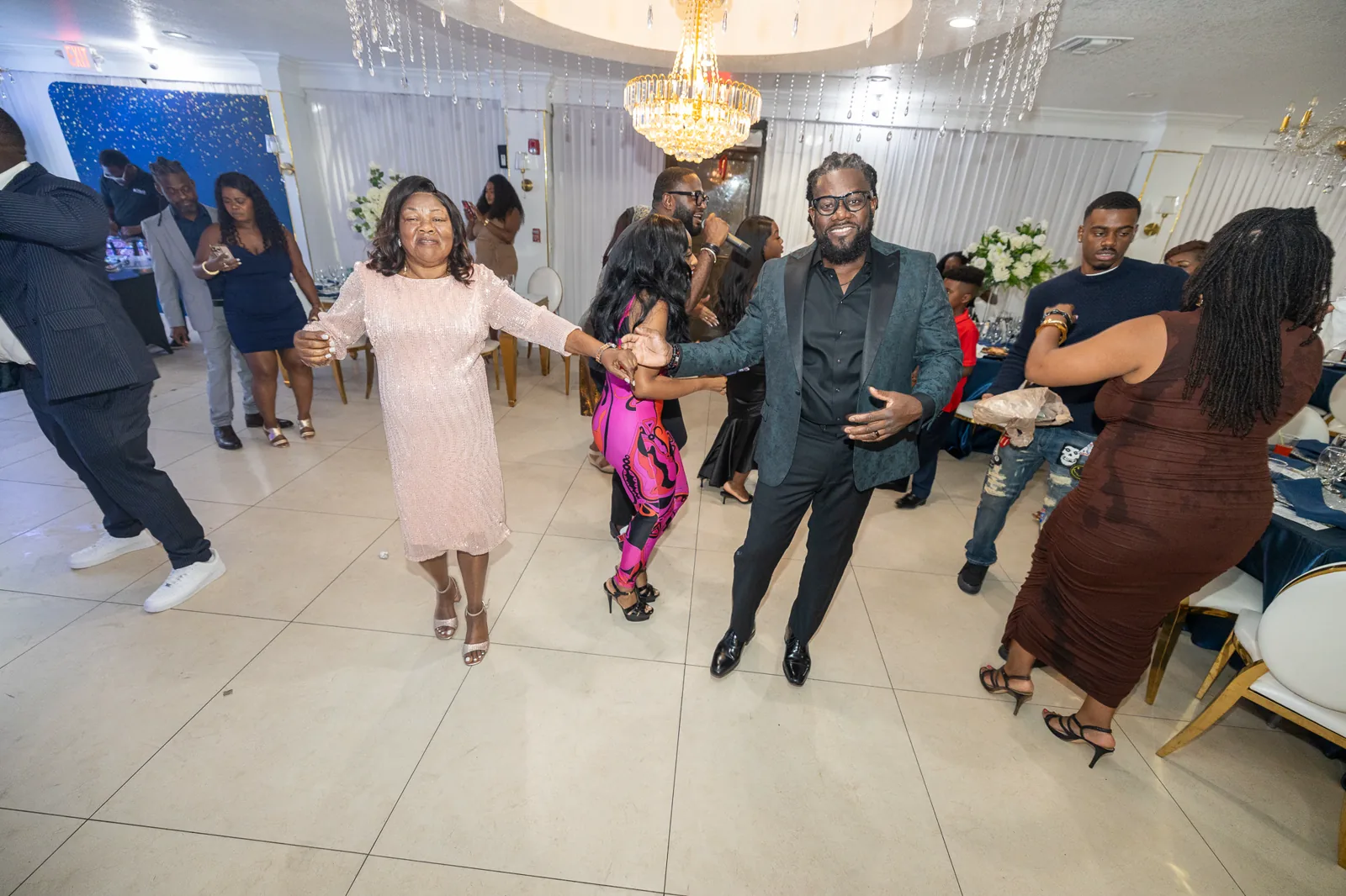 Guests dancing together at a celebration photographed by SkyPoint Media