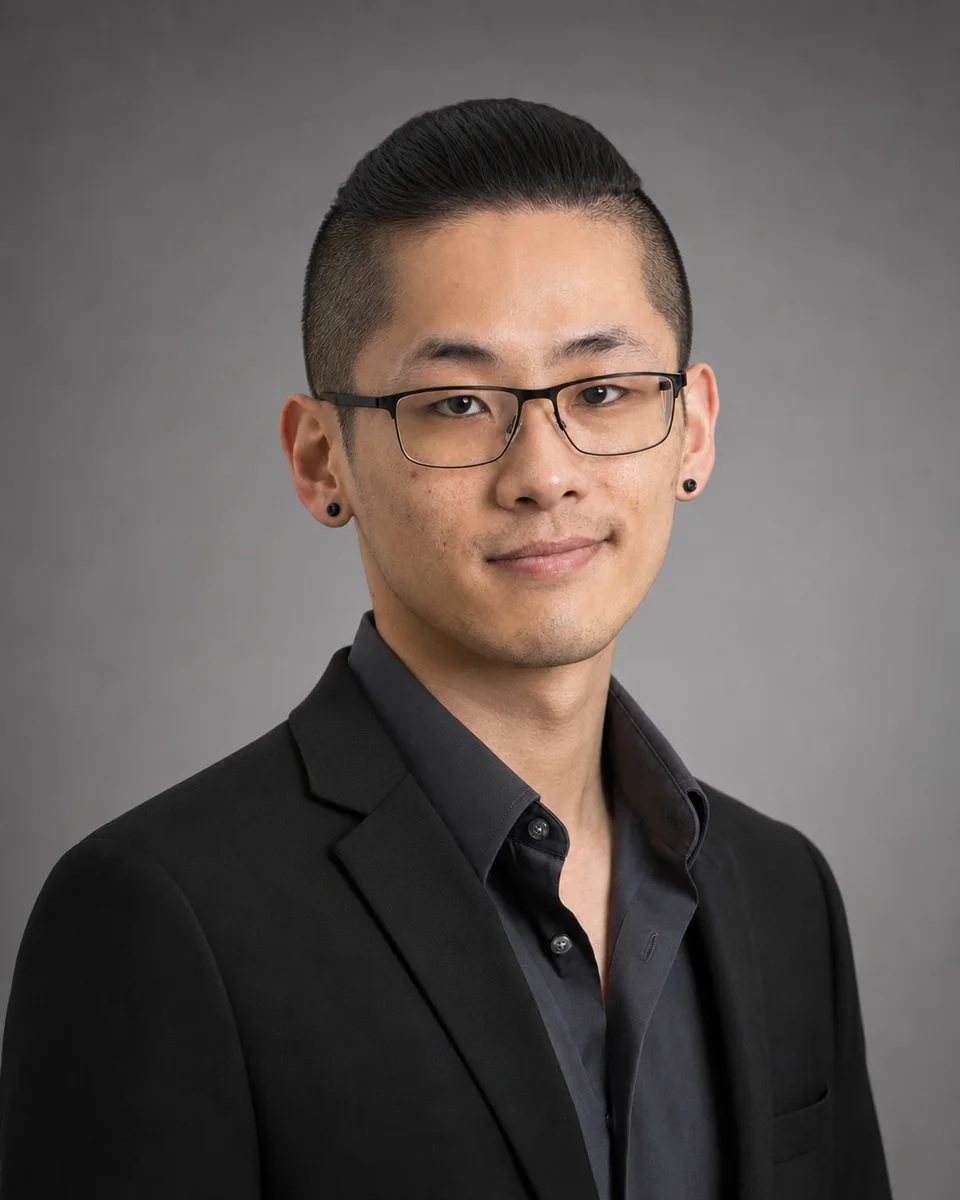 Professional portrait with glasses and a dark suit
